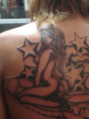 Lady With Star Tattoo On Back